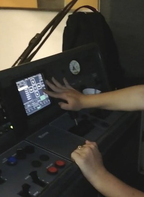 dievča sedí za ovládacím panelom metra